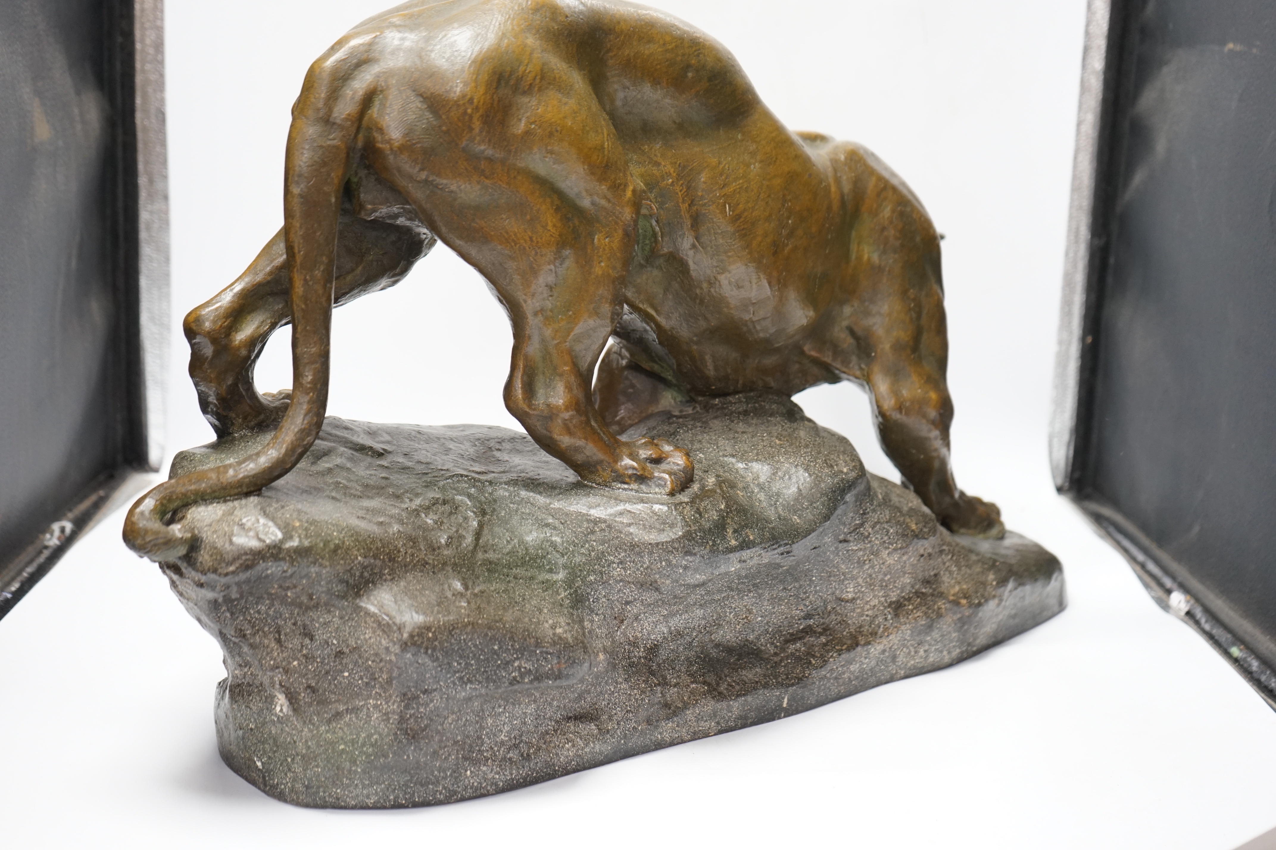 A patinated spelter model of a panther, signed Cartier, approx. 62cm wide